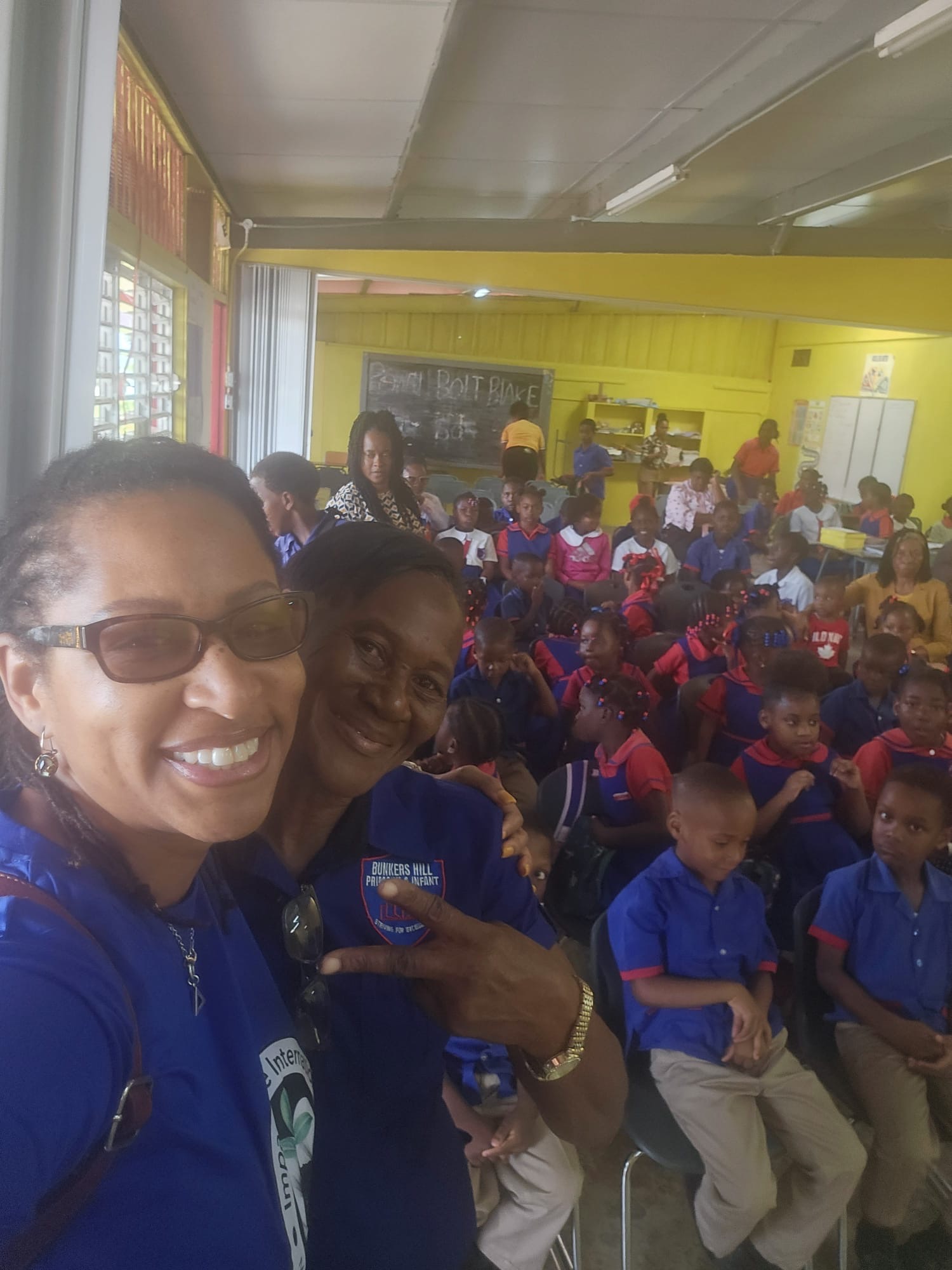 Two adults with students gathered in the classroom at Bunkers Hill Primary and Infant School